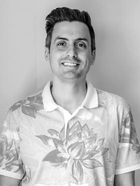 Paul Vlassis smiling, in a floral shirt